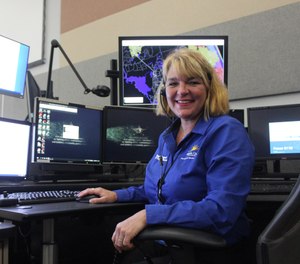 Lead EMS Triage Nurse Pam Cawood sets up for her shift at the Volusia County Emergency Operations building. The county's E-911 Redirect Nurse Triage Program transfers low-acuity calls to specially-trained nurses in order to reduce ambulance dispatches. (Photo/Nikki Ross, The News-Journal)