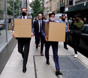 FBI agents carry boxes with evidence after raiding the Sergeants Benevolent Association headquarters in downtown Manhattan early Tuesday, Oct. 5, 2021.