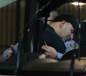 Two SEPTA police officers embrace at Temple University Hospital after a transit officer was shot on the 4700 block of Leiper Street on Wednesday, April 6, 2022, in Philadelphia.