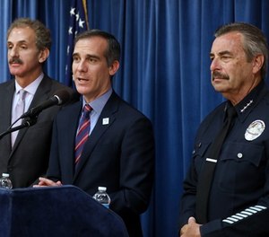 Los Angeles Mayor Eric Garcetti, center, flanked by Los Angeles City Attorney Mike Feuer, left, and LAPD Chief Charlie Beck, during a press conference detailing a court ruling against the Trump administration regarding its efforts to withhold federal grants from jurisdictions over their immigration enforcement policies on Thursday, April 12, 2018 at City Hall in Los Angeles, Calif.