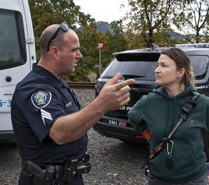 Springfield Police Sgt. Mike Massey shares information with Cahoots Social Worker Amy May during a tour of camping areas in Glenwood. (Photo/Chris Pietsch/The Register-Guard)
