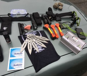 These weapons and tools pictured were among items taken as evidence after a man broke a police patrol vehicle window and pepper-sprayed the officer who sat inside.
