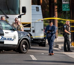 San Bernardino, California, homicide detectives investigate the scene where two San Bernardino Police Officers were wounded in a shootout with a suspect who was allegedly involved in shooting a San Bernardino County Sheriff Deputy the day before, on Wednesday, Aug. 18, 2021, in Highland, California. The suspect died at the scene.