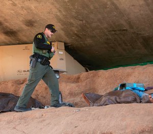 Homeless Outreach Team member Deputy Aaron Bert looks for a person who was living under a bridge and had asked for an appointment to talk with them about getting help.