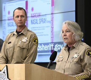 San Diego County Sheriff Kelly Martinez, right, speaks as Assistant Sheriff Brian Nevis looks on at a county news conference.