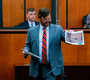 Attorney Josh Kendrick shows a picture of South Carolina’s electric chair as he questions South Carolina Department of Corrections Director Bryan Stirling during a trial concerning the constitutionality of South Carolina execution laws, on Tuesday, Aug., 2, 2022, in the Richland County Courthouse.