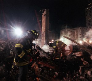 Firefighters from Staten Island's Rescue 5 company search for victims in the pile at Ground Zero in December 2001. Eleven members of the company were killed in the World Trade Center attacks.