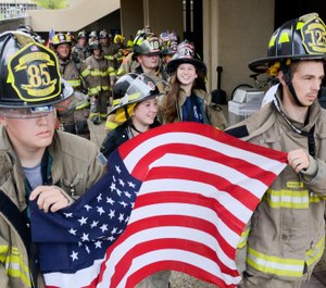 Firefighters and other first responders walk together as a group after climbing 110 flights of stairs during the fifth annual CNY Memorial Stair Climb.(Photo/Tribune News Service by Alex Cooper, Observer-Dispatch)