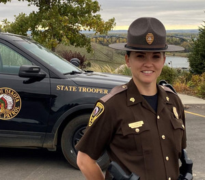 North Dakota Highway Patrol Sgt. Jenna Clawson Huibregtse stands in front of her cruiser in Bismarck, North Dakota.