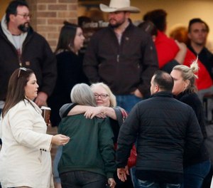 Church and community members gathered outside the West Freeway Church of Christ in Fort Worth before candlelight vigil, Monday evening, Dec. 30, 2019. A gunman shot and killed two parishioners before an armed security officer returned fire, killing him yesterday during their service. (Tom Fox/The Dallas Morning News/TNS)