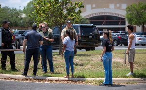 Emergency personnel tell people that Uvalde High School is secure after a school shooting at the nearby Robb Elementary School in Uvalde, Texas.