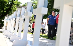 Mourners visit a memorial for the victims of a mass shooting in Uvalde, Texas, on Thursday. Nineteen students and two teachers died when a gunman opened fire in a classroom Tuesday.