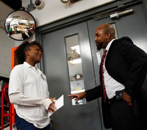 Strawberry Hampton talks with Warden Glen Austin at Logan Correctional Center on Jan. 17, 2019, in Lincoln, Ill. Austin says he sees Hampton no differently from anyone else at the prison.