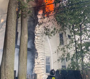 Firefighters battled a six-alarm blaze at the childhood home of Mark Wahlberg on Sunday.