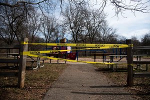 A Michigan playground is marked with caution tape after being closed on Friday, March 27, 2020. Image: mlive.com/Jenna Kieser