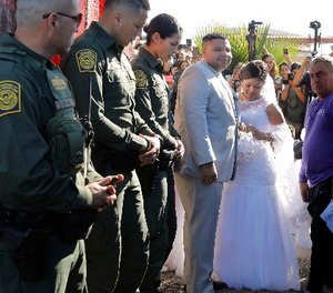 Brian Houston, middle, and Evelia Reyes, right, of Tijuana, are married at the