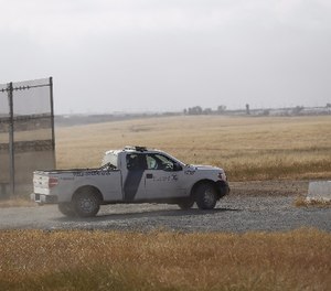 A Customs and Border Protection truck patrols the border fence east of Otay Mesa outside San Diego in April 2017.
