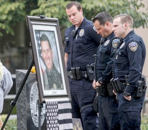 Downey police officers pay their respects at a makeshift memorial for slain Whittier police officer Keith Boyer on Feb. 21, 2017 in Whittier, Calif. (Irfan Khan/Los Angeles Times/TNS)