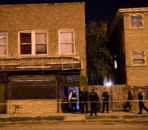 Members of the Chicago Police Department work at the scene of a fatal shooting in the 400 block of East 107th Street Thursday, Nov. 17, 2016, in the Rosemoor neighborhood of Chicago. (Erin Hooley/Chicago Tribune/TNS)