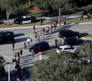 Students are evacuated by police out of Stoneman Douglas High School in Parkland, Fla., after a shooting on Wednesday, Feb. 14, 2018. (Mike Stocker/Sun Sentinel/TNS)