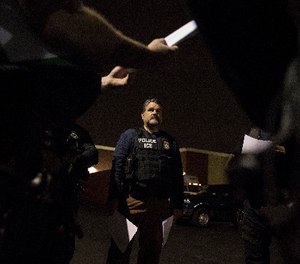 Immigration and Customs Enforcement fugitive operations team assistant director Jorge Field confers with team members in Downey, Calif., on April 18, 2017. (Brian van der Brug/Los Angeles Times/TNS)