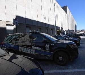 Marked police cars outside the Bishop L. Robinson Sr. building, Baltimore Police headquarters.