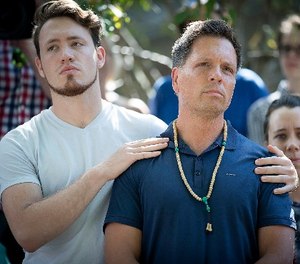 Don Damond is comforted by his son Zach Damond before he made a statement to the press near his home after Minneapolis police officer shot and killed his fiance Justine Damond, Monday, July 17, 2017 in Minneapolis, Minn.