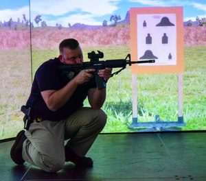 The Utah Attorney General’s Office provides a training center for law enforcement throughout the state. Here, Special Agent Chris Walden hones his marksmanship skills on their VirTra simulated long gun range.