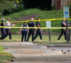 Police work the scene where eleven people were killed during a mass shooting at the Virginia Beach city public works building, Friday, May 31, 2019 in Virginia Beach, Va.