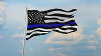 Neighbors fly thin blue line flags after HOA tells slain officer’s father to take his down