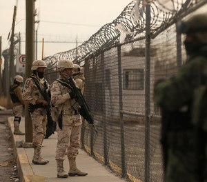 Members of the Mexican Army secure an area outside the prison of Ciudad Juarez number 3 after gunmen attacked the prison, leaving 14 people dead and allowing 24 inmates to escape. The dead included 10 correctional officers and security agents.