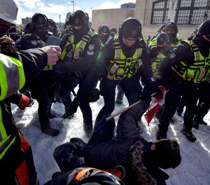 Police clash with demonstrators against COVID-19 mandates in Ottawa on Feb. 18, 2022.