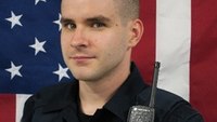 Va. officer fatally shot during struggle with assault suspect in woods
