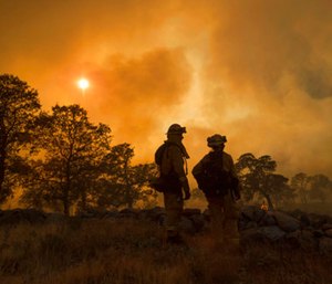 The fast-moving wildfire in the Sierra Nevada foothills destroyed structures, including homes, and led to several minor injuries, fire officials said Saturday as blazes threatened homes around California during a heat wave. (AP Photo/Noah Berger)