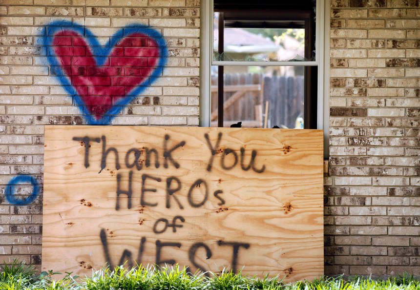 A home spray painted with a heart and an inspirational message, damaged by the fertilizer plant explosion along Reagan Street is shown Friday, May 31, 2013, in West, Texas.