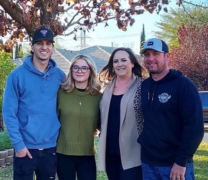 Chris (right) with his wife, Amber, and their kids.