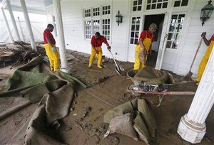 Workers begin the cleanup of the Old White Course on the property of the Greenbrier Resort in White Sulphur Springs, W. Va., on June 28, 2016. Image: AP Photo/Steve Helber