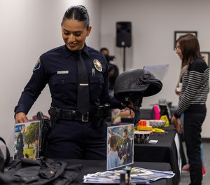 Santa Ana Police Department officers set up booths for the women’s hiring expo.