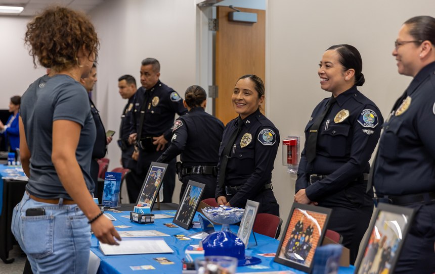 Santa Ana Police Department officers explain their roles within their department to participants at the women’s hiring expo.