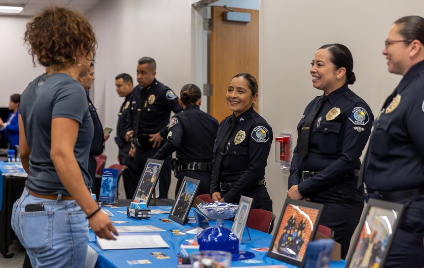 Santa Ana Police Department officers explain their roles within their department to participants at the women’s hiring expo.