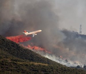A brush fire threatened structures Wednesday in the north-central Arizona town of Yarnell — the scene of a 2013 wildfire in which 19 members of an elite firefighting crew were killed. (Les Stukenberg/The Daily Courier via AP)