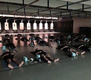 Recruits from the Des Moines Police Academy practice yoga as part of their academy curriculum.