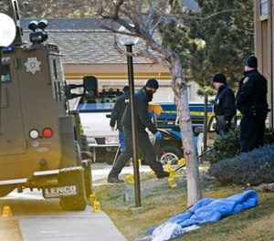 Authorities investigate the shooting of several sheriff's deputies in an apartment complex in Denver on Sunday, Dec. 31, 2017. (Helen H. Richardson/The Denver Post via AP)