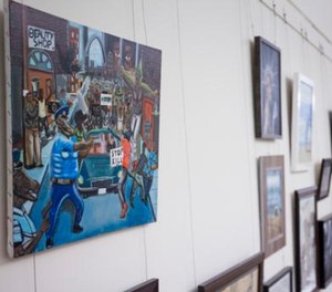 In this Jan. 5, 2017 file photo, a painting by David Pulphus hangs in a hallway displaying paintings by high school students selected by their member of congress on Capitol Hill in Washington. A student's painting that divided members of Congress for its depiction of Ferguson, Mo., has been removed from its Capitol Hill display, this time more permanently.