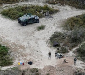 In this Feb. 24, 2015, file photo, members of the National Guard patrol along the Rio Grande at the Texas-Mexico border in Rio Grande City, Texas. (AP Photo/Eric Gay, File)