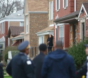 Authorities gather outside a home on the South Side of Chicago, Monday morning, April 10, 2017, after Cook County Circuit Court Judge Raymond Myles was shot to death outside his home. (Zbigniew Bzdak/Chicago Tribune via AP)