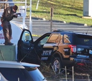 Arnold Police investigate the scene of a shooting of one of their own officers on Tuesday, Dec. 5, 2017, in the parking lot of the Arnold Police Station in Arnold, Mo.
