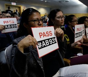 Rosa Cabrera, foreground, joined others in support of a measure to limit police use of deadly force, during a hearing of the Senate Public Safety Committee, Tuesday, June 19, 2018, in Sacramento, Calif.