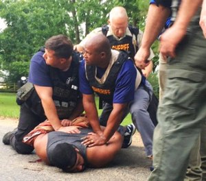 Officers arrest suspect Cory Godbolt on Sunday, May 28, 2017, following several fatal shootings Saturday in Lincoln County, Miss., officials said. (Therese Apel/The Clarion-Ledger via AP)