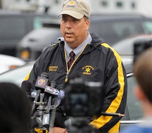 St. Lawrence County Sheriff Kevin M. Wells briefs the media on Friday, in Heuvelton, N.Y., on the investigation into the abduction of two Amish sisters from the family’s roadside vegetable stand on Wednesday.